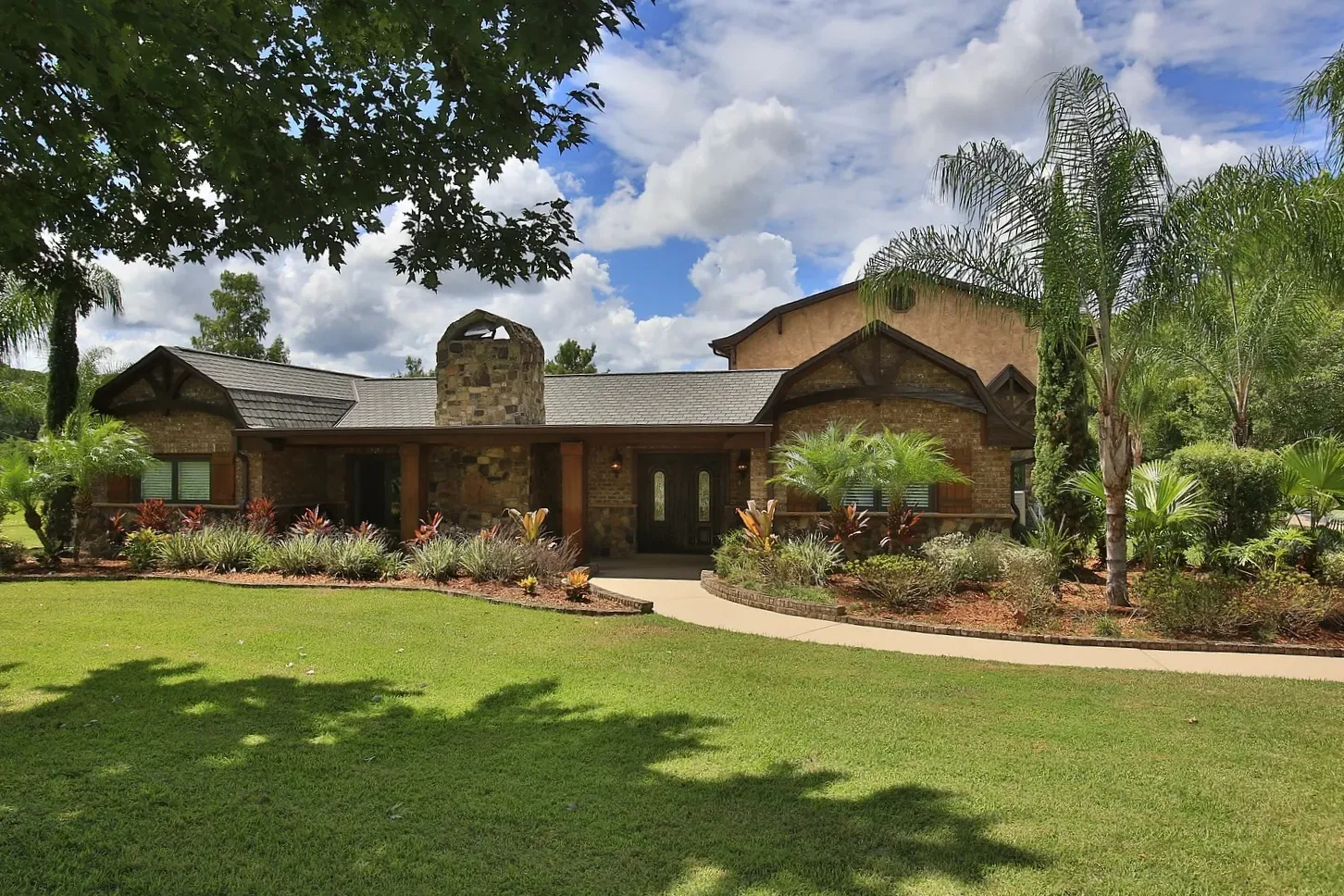 A rustic elegance home renovation by Ben Butera signature design, boasts a modern courtyard, outstanding landscape architecture, and a custom-built home addition to elevate property value and build owner's dream home.