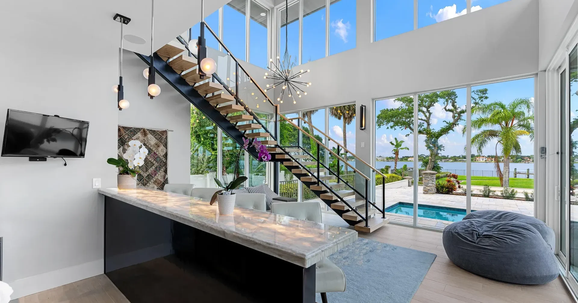 Architect Ben Butera luxury custom home bar, floating stairs, river dock, infinity pool and water view of the Halifax River