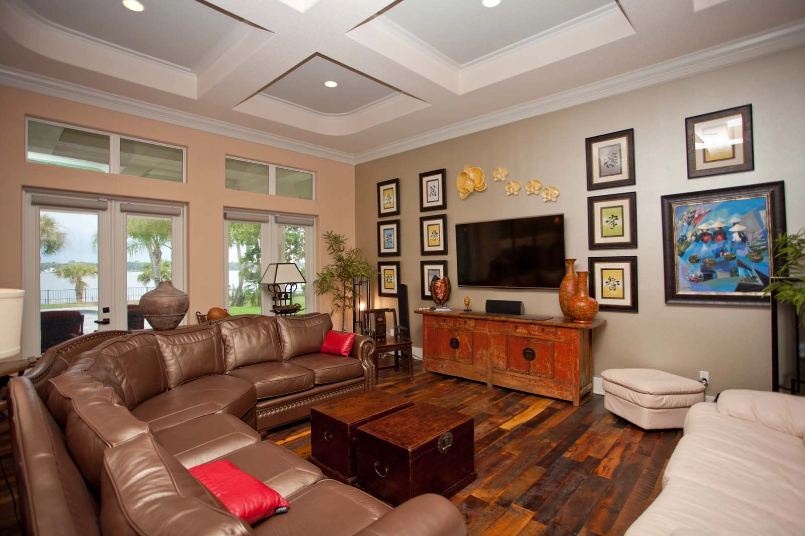 Living room with coffered ceiling with recessed lighting, large windows and water views by architect Benjamin P. Butera.