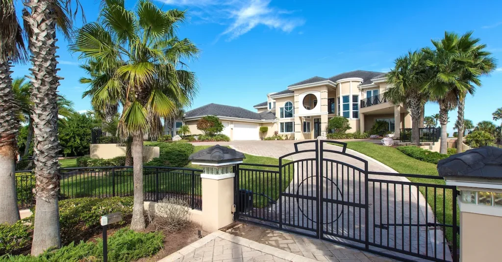Luxury custom oceanfront home with elegant front gates and eclectic design by Benjamin P. Butera in Daytona Beach Shores.