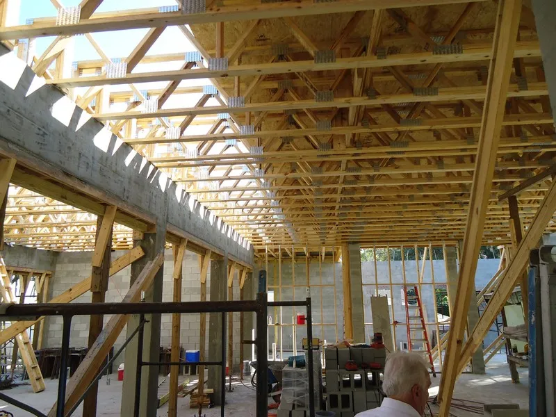 Construction site features exposed beams in a Butera Designs architecture firm waterfront custom-built home in Ormond Beach