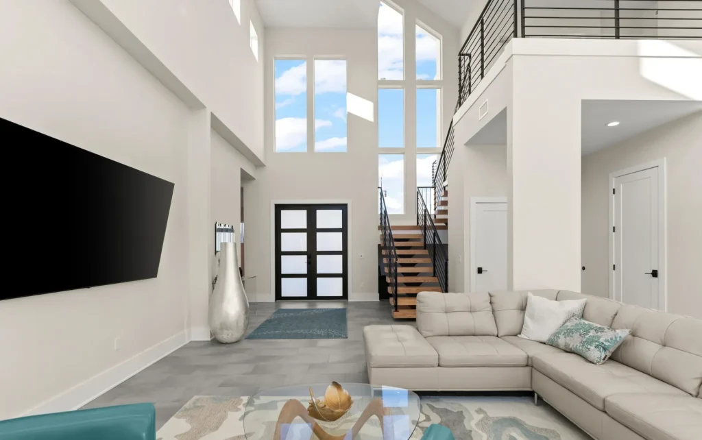 Sustainable Contemporary High Ceilings Entrance Scaled A Benjamin P. Butera luxury home with large glass windows for ocean views and energy-efficiency, and coastal interior design.